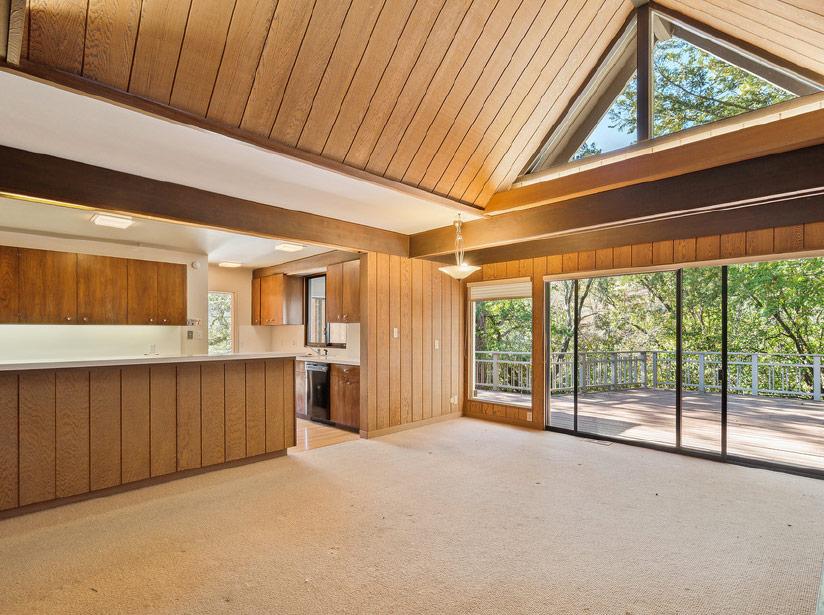 Room with wood paneling and large windows